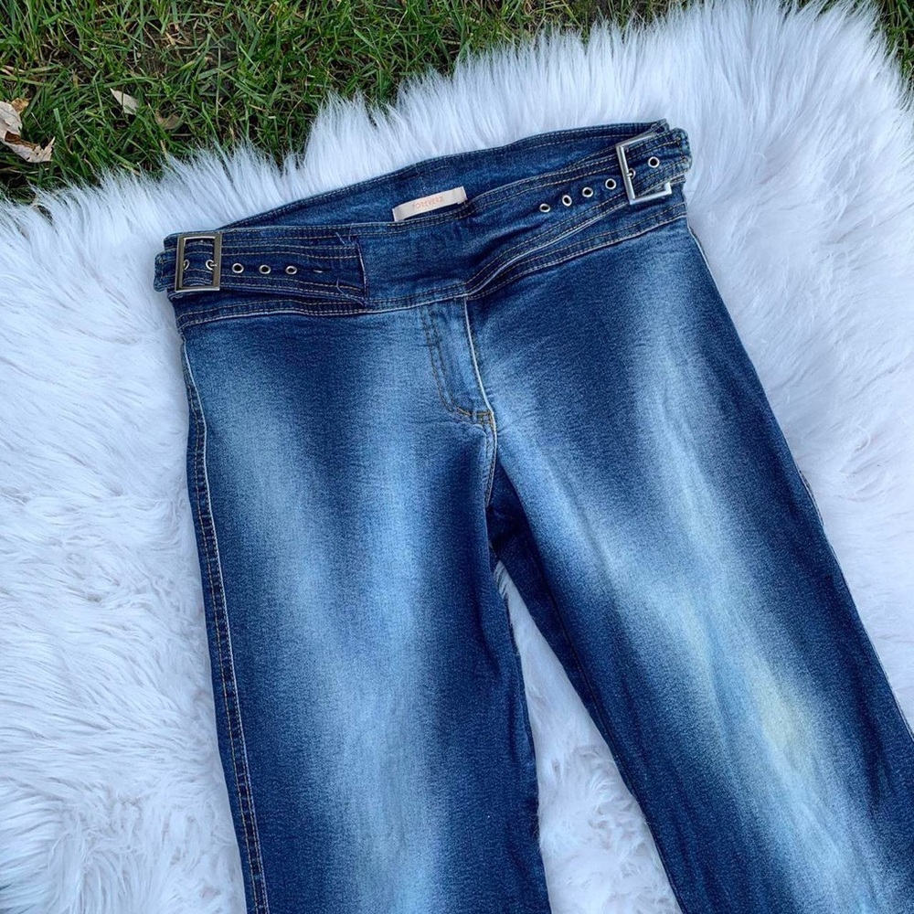 Vintage Y2K era low rise flared jeans with buckles on the sides